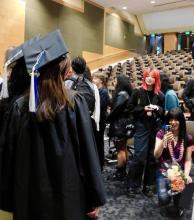 Graduates take photos after the celebration. 