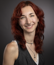 A young woman smiling.
