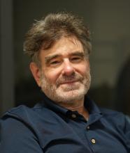 A man smiling in a polo shirt.