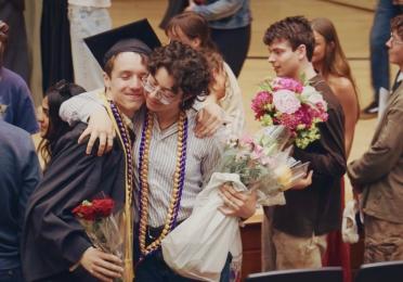 Two CMS Graduates Hugging