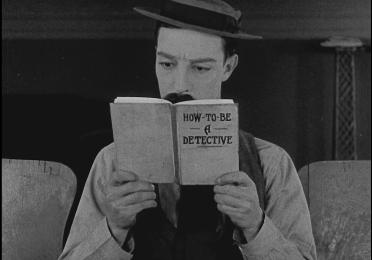 Man reads a book titled 'How to Be a Detective'
