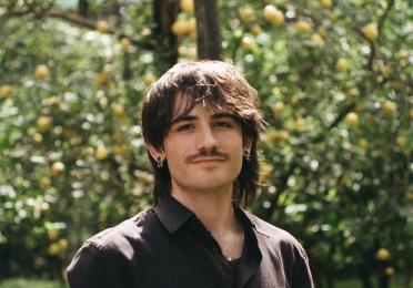 Headshot of person wearing black shirt
