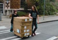 CMS major Allie Smith bringing equipment into Padelford (also pictured: CMS Chair Stephen Groening)