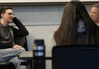 Two men talking to one another.