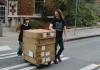 CMS major Allie Smith bringing equipment into Padelford (also pictured: CMS Chair Stephen Groening)