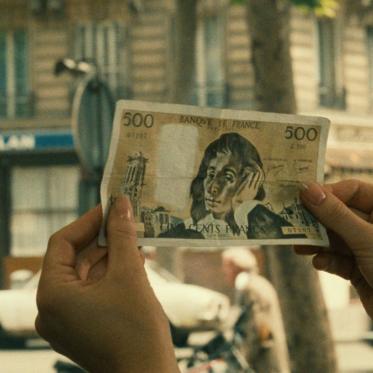 A pair of hands hold up money.