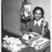 Black and white photo of Graciela Gil Olivarez on the air at KIFN radio, 1961